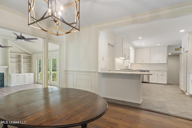 3831 Tyrone Dr, Jackson, MS 39216 - dining space featuring a ceiling fan, built in shelves, a chandelier, wood finished floors, and lofted ceiling