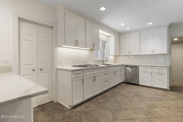 3831 Tyrone Dr, Jackson, MS 39216 - kitchen featuring appliances with stainless steel finishes, white cabinets, tasteful backsplash, and recessed lighting