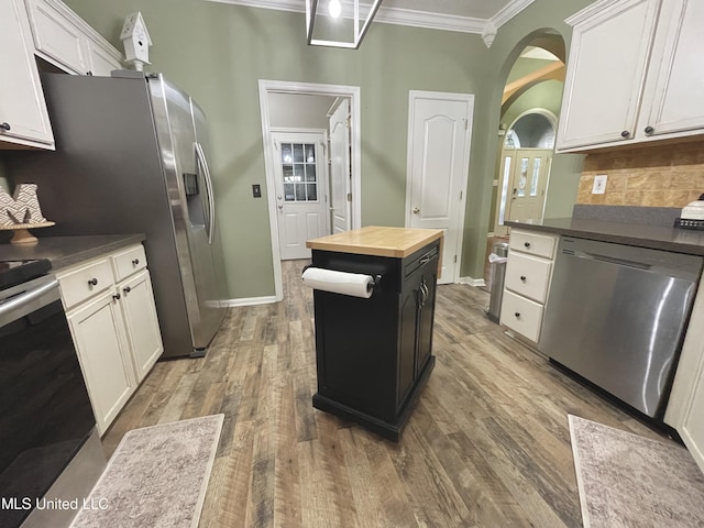5269 Blocker St, Olive Branch, MS 38654 - kitchen with stainless steel appliances, wooden counters, ornamental molding, arched walkways, and tasteful backsplash