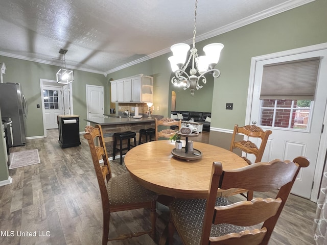5269 Blocker St, Olive Branch, MS 38654 - dining space featuring wood finished floors, a chandelier, and ornamental molding
