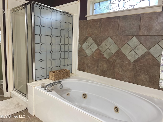 5269 Blocker St, Olive Branch, MS 38654 - bathroom with a stall shower, a jetted tub, and tile patterned flooring