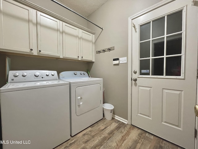 5269 Blocker St, Olive Branch, MS 38654 - laundry room featuring cabinet space, separate washer and dryer, wood finished floors, and a textured ceiling