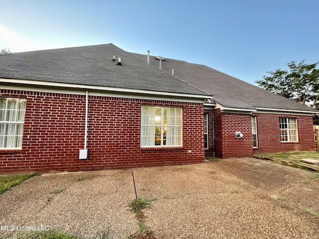 5269 Blocker St, Olive Branch, MS 38654 - back of house with roof with shingles, a patio, and brick siding
