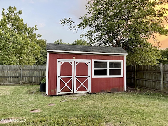 5269 Blocker St, Olive Branch, MS 38654 - outdoor structure at dusk featuring a storage shed and a fenced backyard