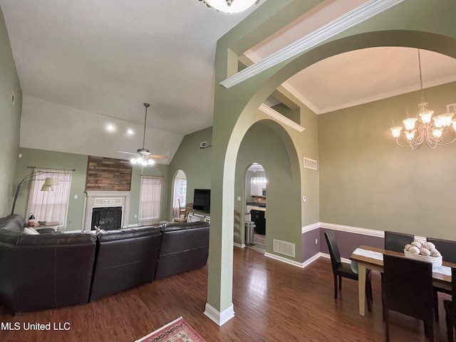 5269 Blocker St, Olive Branch, MS 38654 - living area featuring a fireplace, wood finished floors, ceiling fan, a chandelier, and vaulted ceiling