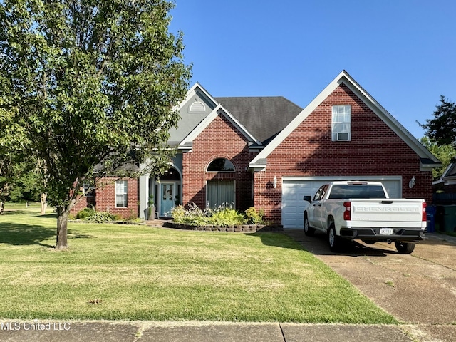5269 Blocker St, Olive Branch, MS 38654 - traditional-style home featuring driveway, brick siding, and a front lawn