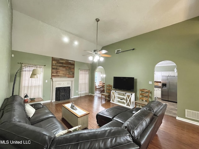 5269 Blocker St, Olive Branch, MS 38654 - living area featuring arched walkways, wood finished floors, ceiling fan, a large fireplace, and high vaulted ceiling