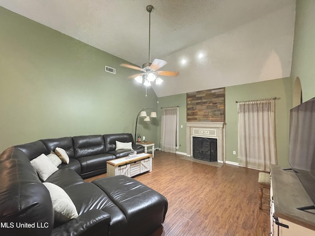 5269 Blocker St, Olive Branch, MS 38654 - living room featuring ceiling fan, wood finished floors, high vaulted ceiling, and a fireplace with flush hearth