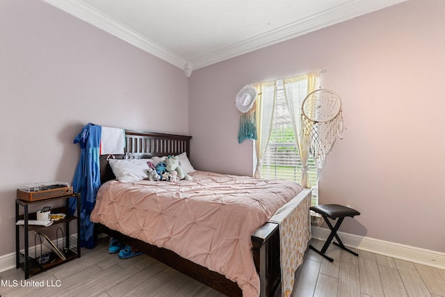 bedroom with light hardwood / wood-style flooring and crown molding