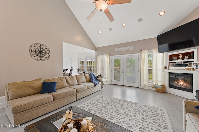 living room featuring french doors, ceiling fan, high vaulted ceiling, and light hardwood / wood-style flooring