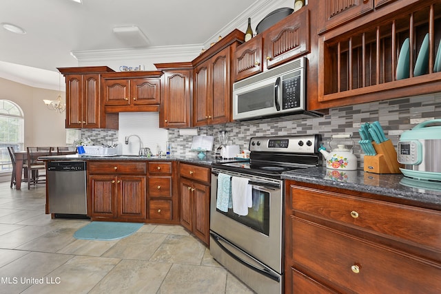 kitchen featuring tasteful backsplash, a chandelier, sink, crown molding, and stainless steel appliances