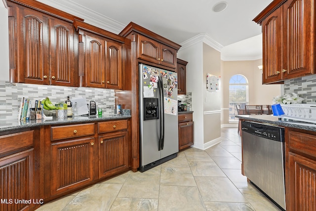 kitchen with tasteful backsplash, appliances with stainless steel finishes, ornamental molding, and dark stone counters