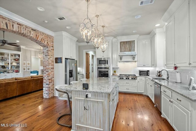 kitchen with white cabinets, a kitchen island, and stainless steel appliances