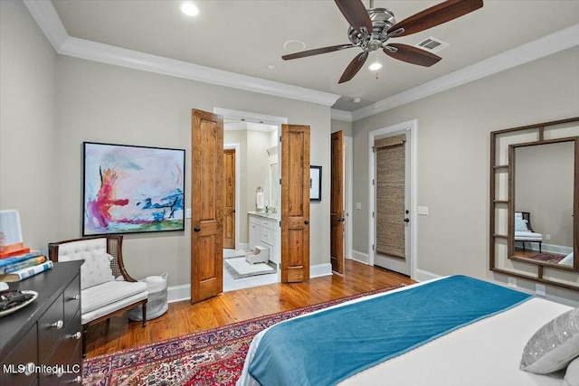 bedroom featuring ceiling fan, ensuite bathroom, crown molding, and light hardwood / wood-style flooring