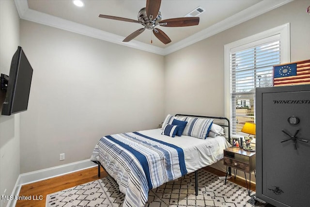 bedroom with ceiling fan, light hardwood / wood-style flooring, and ornamental molding