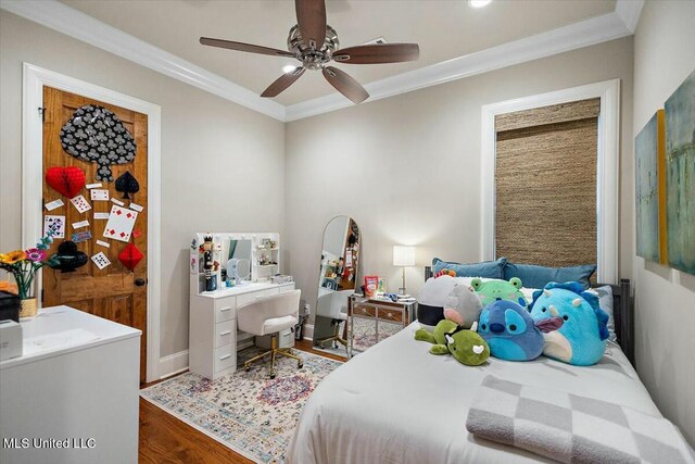 bedroom featuring ceiling fan, ornamental molding, and hardwood / wood-style flooring