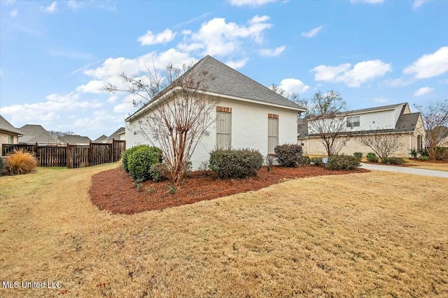 view of side of home featuring a lawn