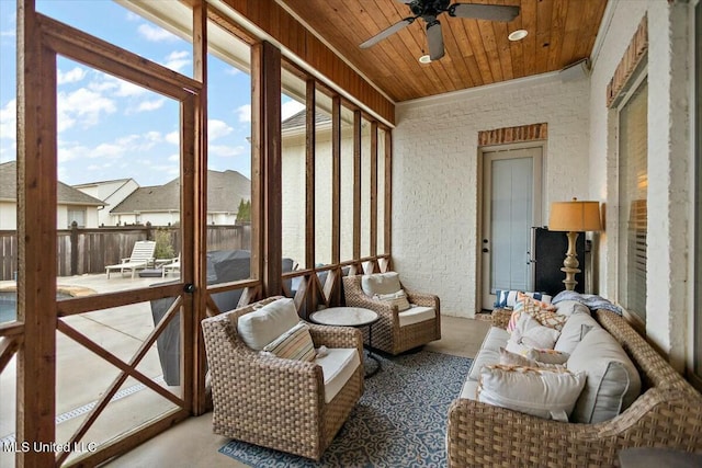 sunroom / solarium with ceiling fan and wood ceiling