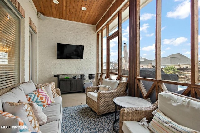 sunroom featuring a wealth of natural light and wooden ceiling