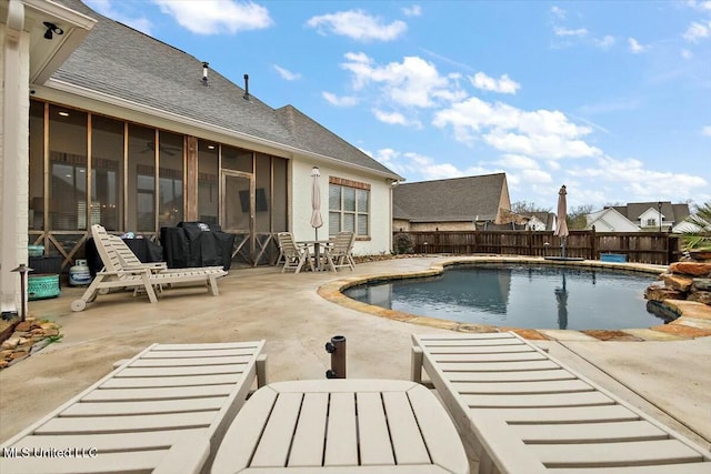 view of pool with a patio area and a sunroom