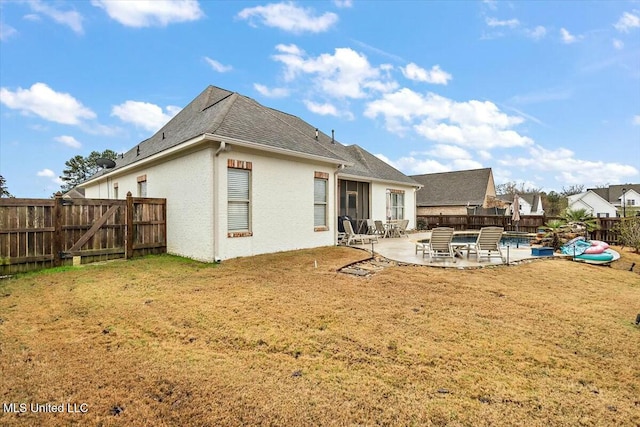 back of house with a yard, a patio, and a pool