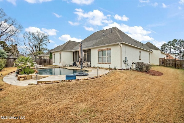 back of house featuring a fenced in pool, a patio area, and a lawn