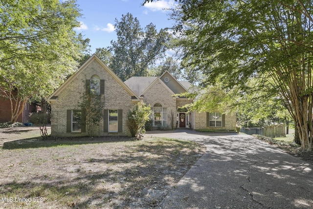 view of front of house featuring driveway and brick siding