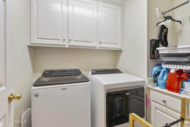 washroom with separate washer and dryer and cabinet space