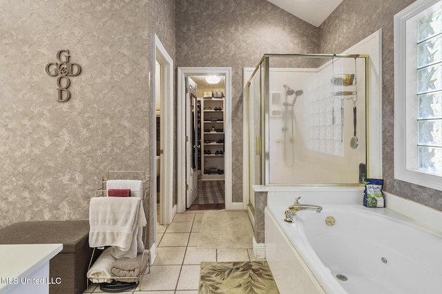 full bathroom featuring a stall shower, a spacious closet, a tub with jets, and wallpapered walls