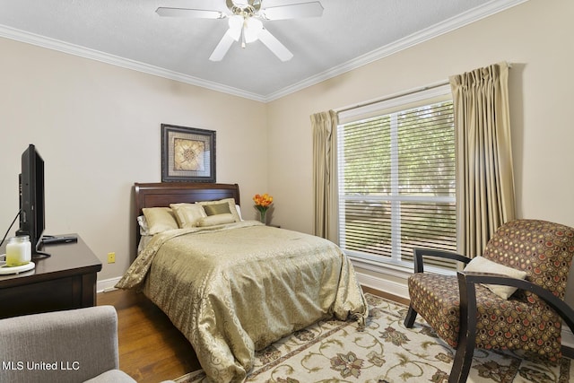 bedroom with ceiling fan, ornamental molding, dark wood finished floors, and baseboards