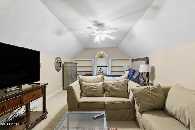 living room with lofted ceiling, a textured ceiling, light colored carpet, a ceiling fan, and baseboards