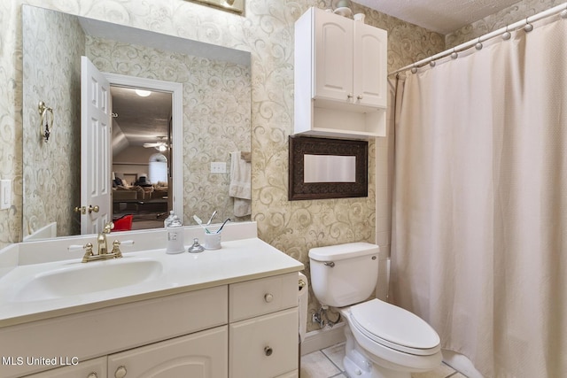 bathroom with toilet, wallpapered walls, tile patterned flooring, and vanity