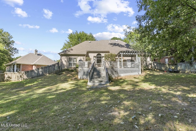 back of house with a fenced backyard, a lawn, a deck, and a pergola