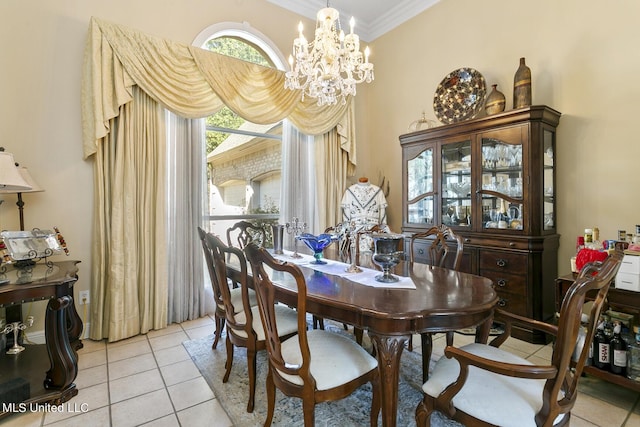 dining space featuring ornamental molding, a chandelier, and light tile patterned flooring