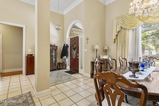 entryway with a chandelier, ornamental molding, and light tile patterned flooring