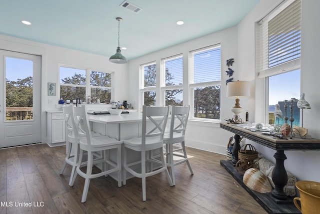 dining area with visible vents, plenty of natural light, and dark wood finished floors