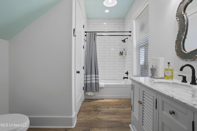 full bathroom featuring vanity, shower / tub combo, toilet, and wood finished floors