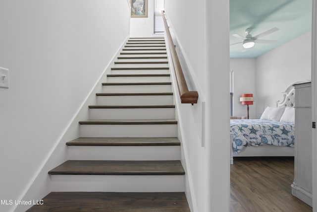 stairs with wood finished floors and ceiling fan