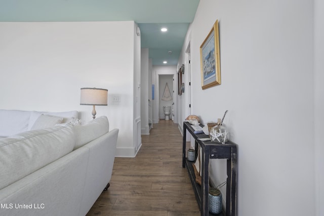 hall with dark wood-type flooring, recessed lighting, and baseboards