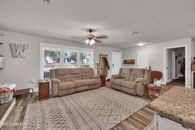 living room with hardwood / wood-style flooring and ceiling fan