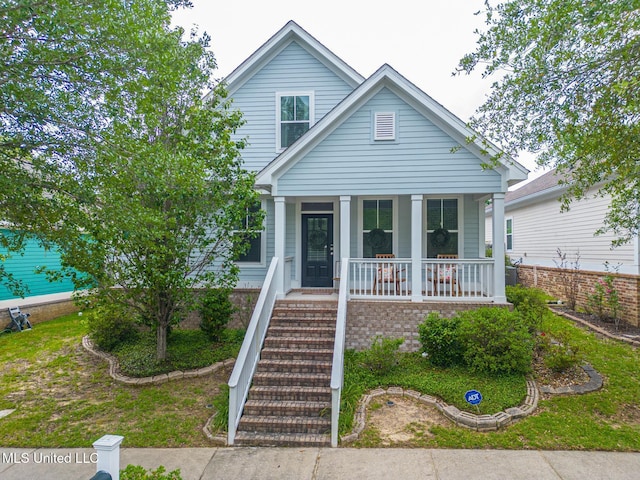 bungalow-style home featuring stairway and covered porch