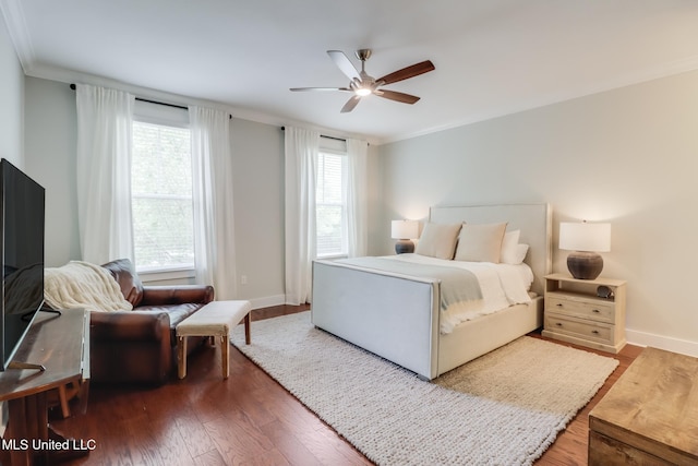 bedroom featuring crown molding, a ceiling fan, wood finished floors, and baseboards