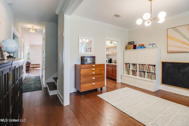 interior space featuring visible vents, ornamental molding, dark wood finished floors, and baseboards