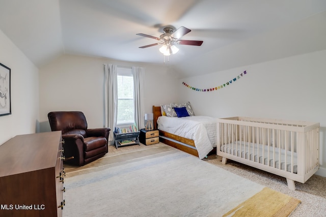 bedroom with a ceiling fan, carpet flooring, and vaulted ceiling