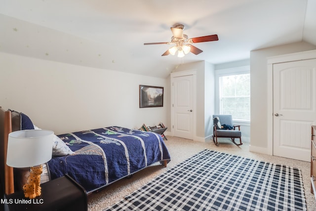 carpeted bedroom featuring lofted ceiling, ceiling fan, and baseboards