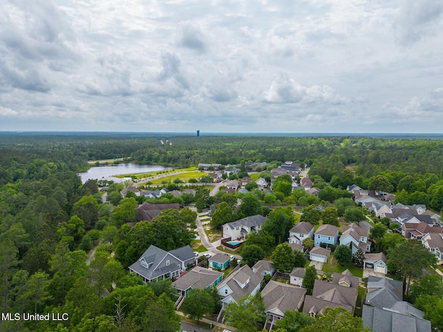 aerial view with a wooded view, a residential view, and a water view