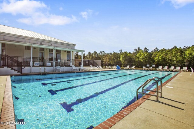 pool featuring fence and a patio area