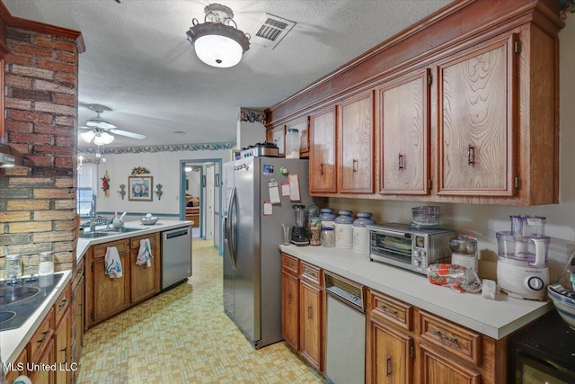 kitchen featuring ceiling fan, sink, a textured ceiling, and appliances with stainless steel finishes