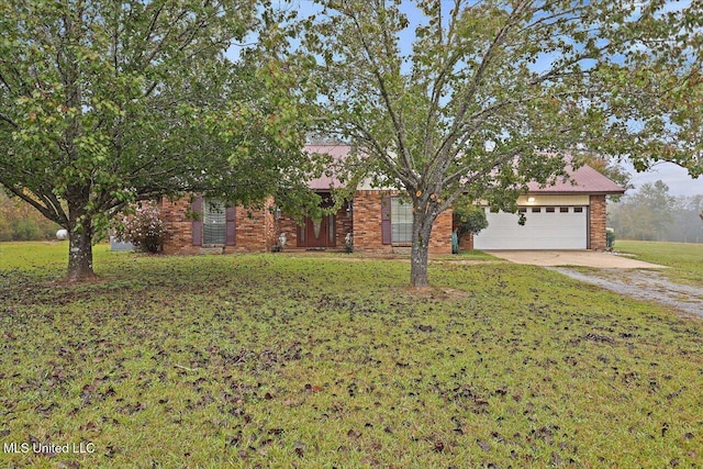 view of front of property with a garage and a front lawn