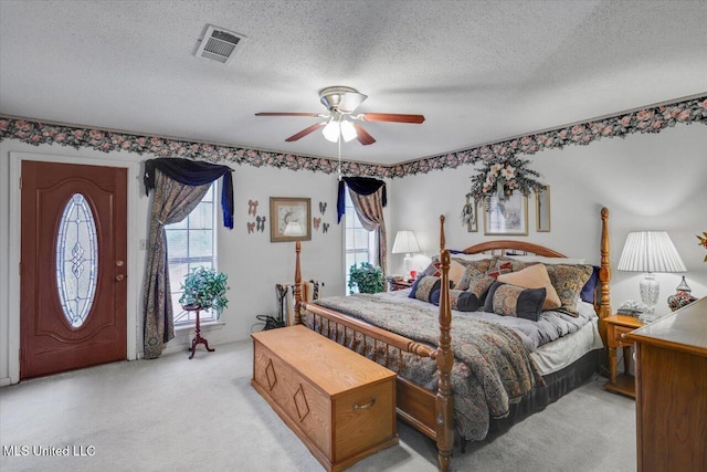 carpeted bedroom with a textured ceiling and ceiling fan